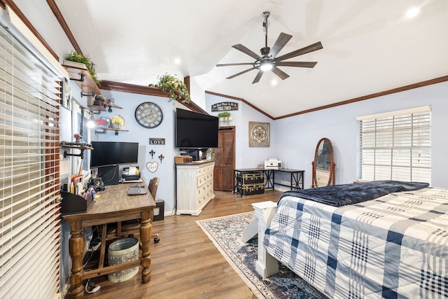 bedroom with crown molding, light wood-style floors, and vaulted ceiling