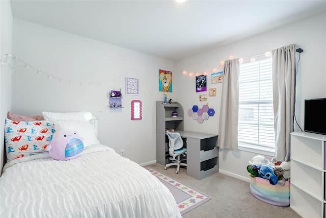 bedroom featuring light colored carpet and multiple windows