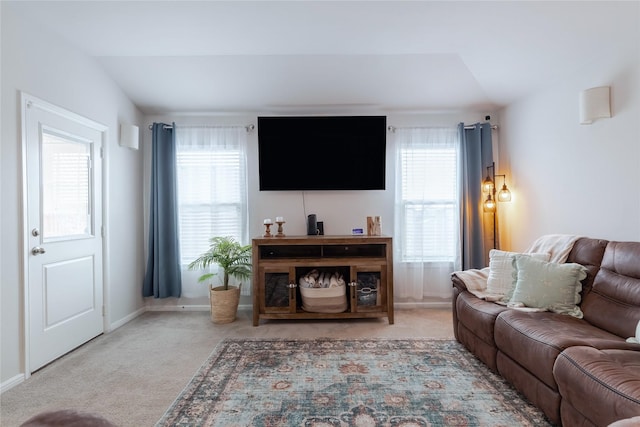 carpeted living room featuring a healthy amount of sunlight and vaulted ceiling