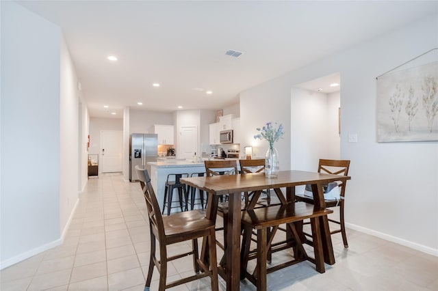 dining space featuring light tile patterned floors