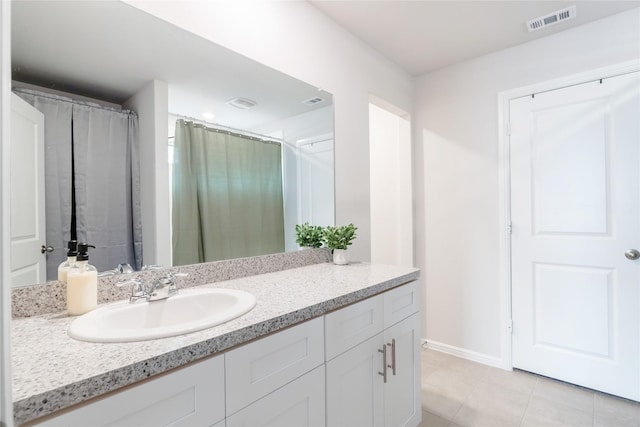 bathroom with tile patterned flooring and vanity