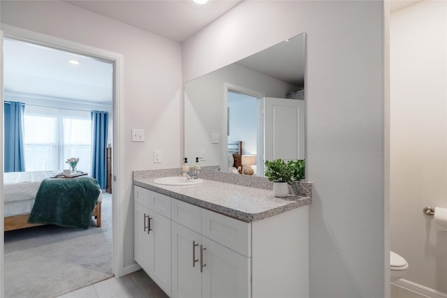 bathroom featuring toilet, vanity, and tile patterned flooring