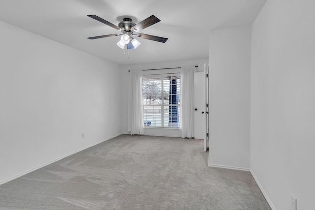 unfurnished room featuring light colored carpet and ceiling fan