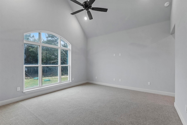 carpeted empty room featuring high vaulted ceiling and ceiling fan