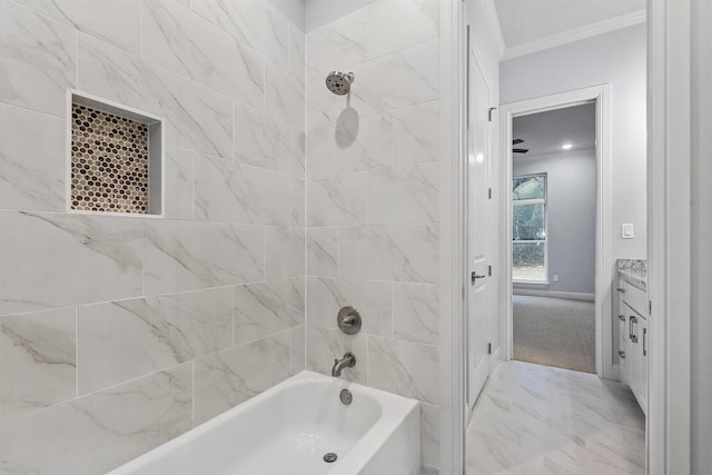 bathroom with tiled shower / bath combo, crown molding, and vanity