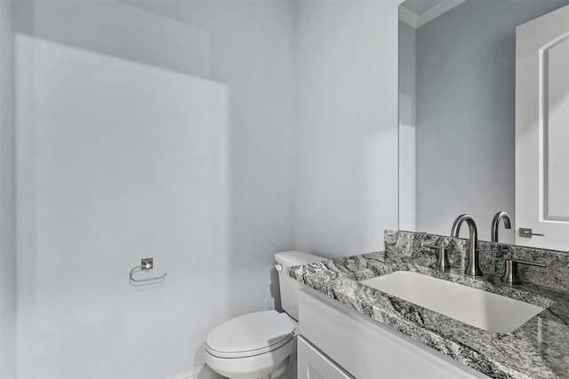 bathroom featuring vanity, toilet, and crown molding