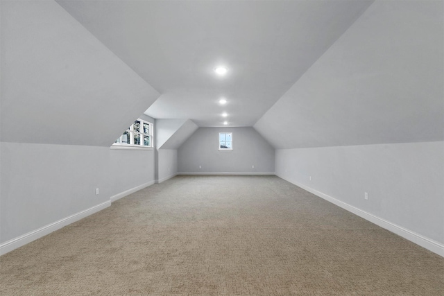 bonus room featuring vaulted ceiling and carpet flooring