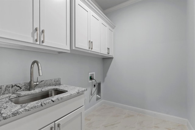 clothes washing area with sink, cabinets, washer hookup, and crown molding