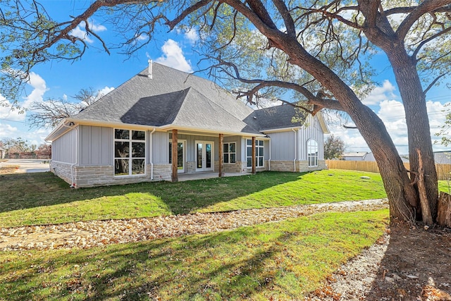 back of house with a lawn