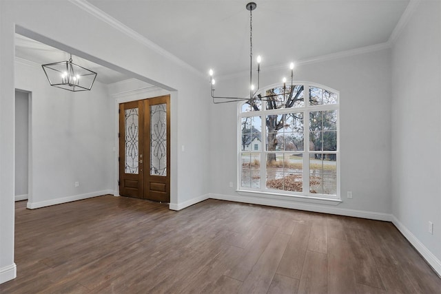 entryway featuring ornamental molding, an inviting chandelier, and dark hardwood / wood-style floors