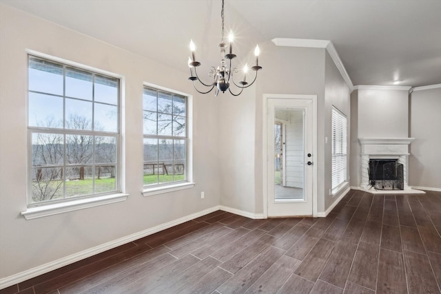 unfurnished dining area featuring crown molding, a chandelier, a wealth of natural light, and dark hardwood / wood-style flooring