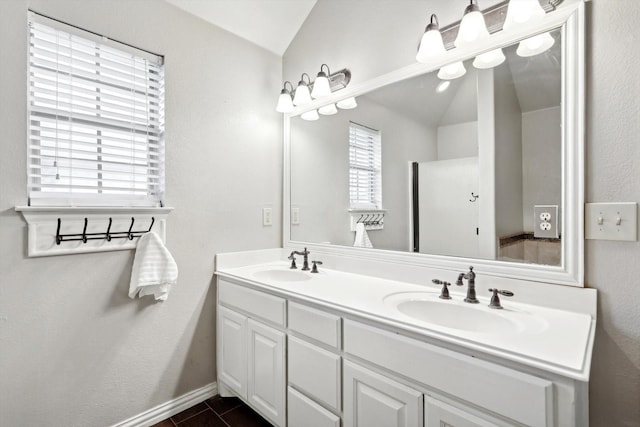 bathroom with tile patterned floors, vanity, and lofted ceiling