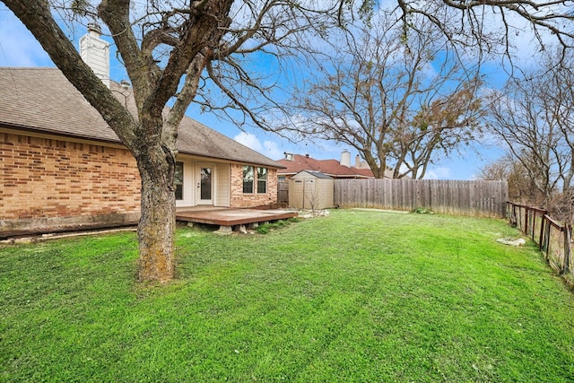 view of yard with a storage unit and a deck