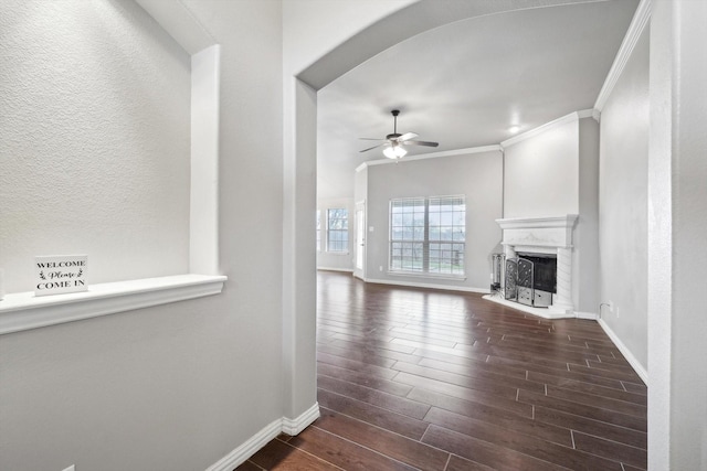 unfurnished living room featuring crown molding and ceiling fan