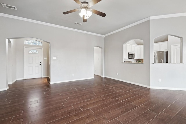 unfurnished living room with crown molding, dark wood-type flooring, and ceiling fan