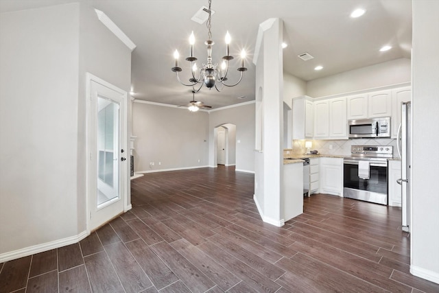 kitchen with crown molding, hanging light fixtures, white cabinets, stainless steel appliances, and ceiling fan with notable chandelier