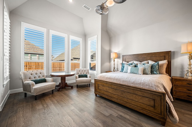 bedroom with dark hardwood / wood-style flooring and vaulted ceiling