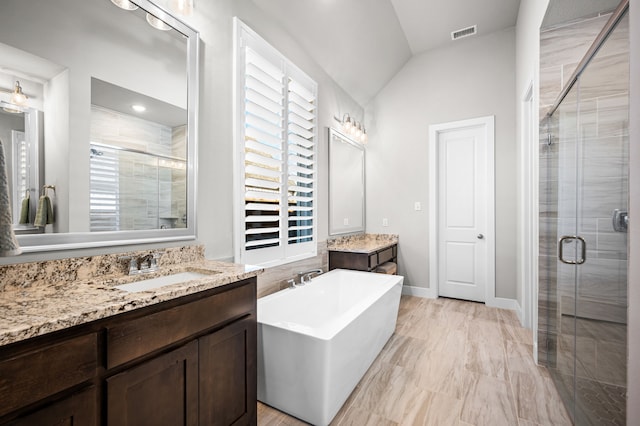 bathroom featuring vanity, lofted ceiling, and plus walk in shower