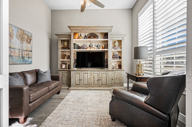 living room with light wood-type flooring and ceiling fan