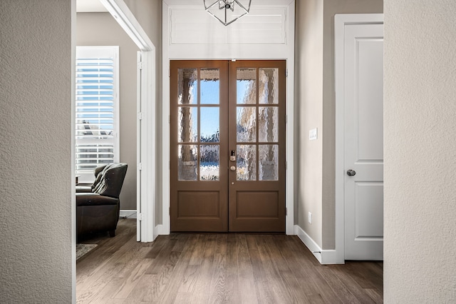 foyer entrance featuring hardwood / wood-style floors and french doors