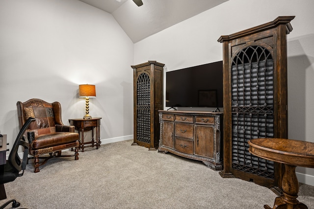 sitting room with ceiling fan, light carpet, and lofted ceiling