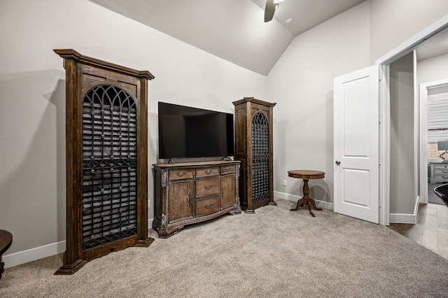 carpeted bedroom featuring ceiling fan and vaulted ceiling