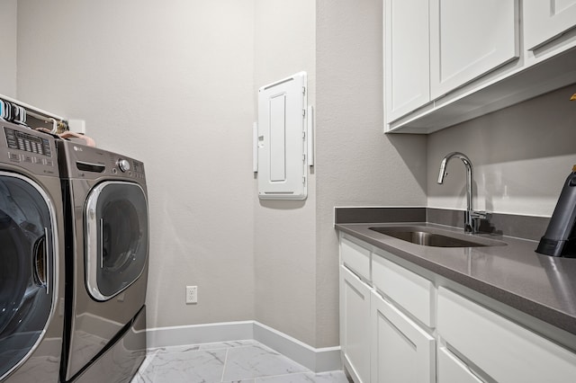 clothes washing area featuring sink, electric panel, cabinets, and independent washer and dryer