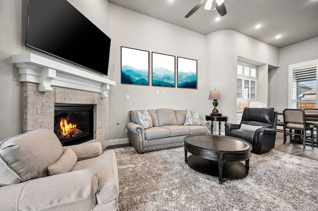 living room with a fireplace, hardwood / wood-style floors, and ceiling fan