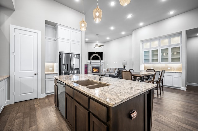 kitchen with backsplash, sink, white cabinetry, and appliances with stainless steel finishes