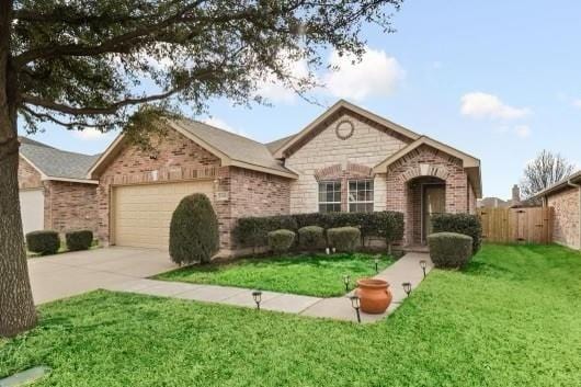 single story home featuring a garage and a front lawn