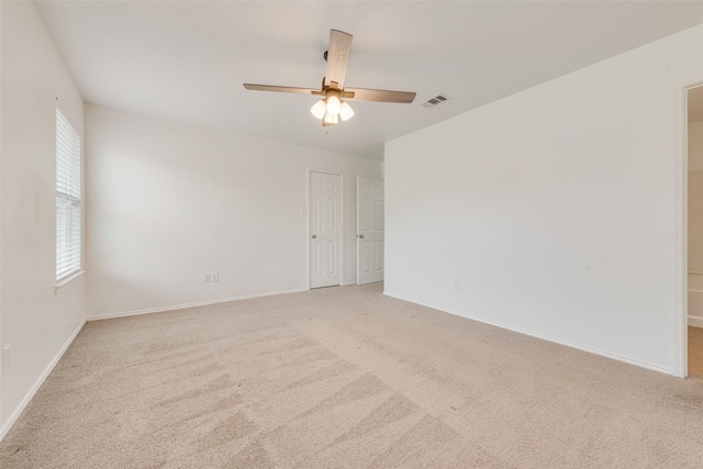 empty room with light colored carpet and ceiling fan