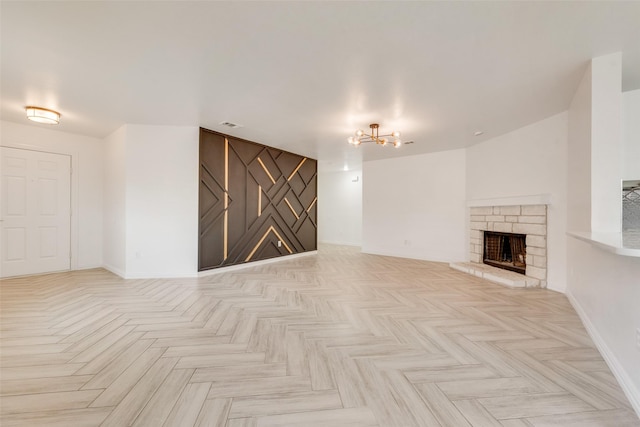 unfurnished living room with light parquet floors and a fireplace