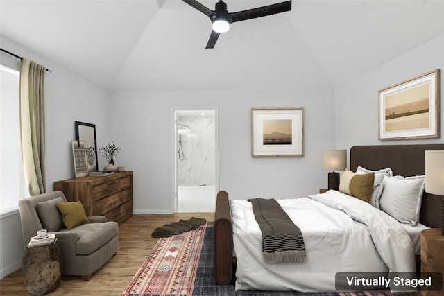 bedroom featuring light hardwood / wood-style flooring, connected bathroom, vaulted ceiling, and ceiling fan