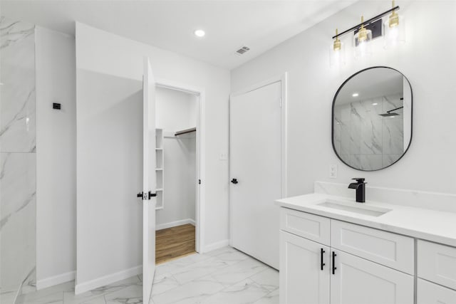 bathroom with walk in shower and vanity