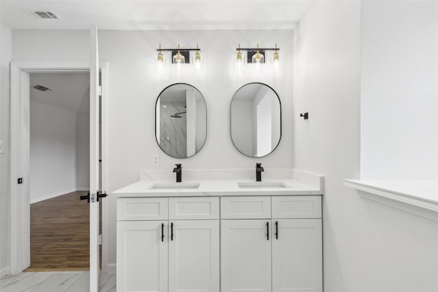 bathroom featuring walk in shower and vanity