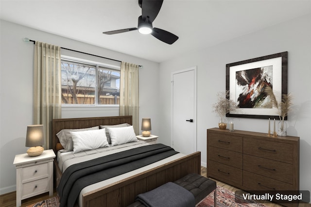 bedroom with ceiling fan and hardwood / wood-style floors