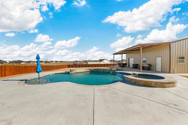 view of swimming pool with an in ground hot tub and a patio area