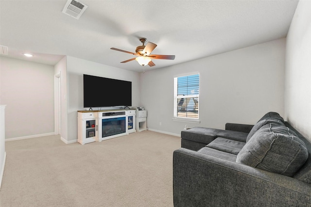 carpeted living room featuring ceiling fan