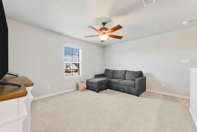 carpeted living room featuring ceiling fan