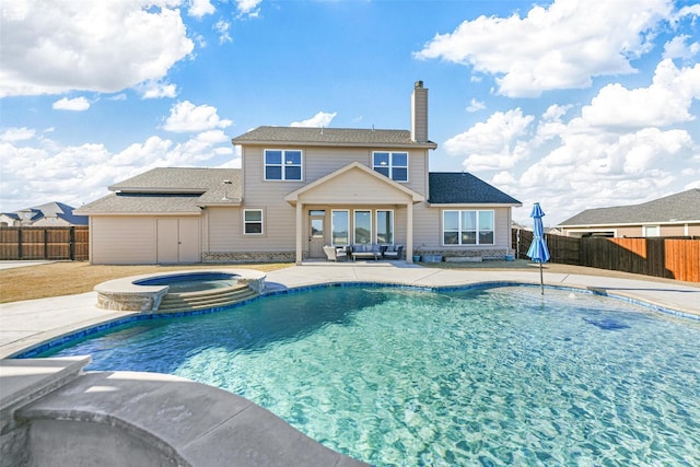 view of swimming pool featuring an in ground hot tub and a patio area