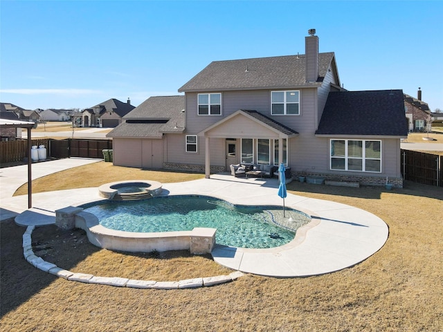 view of swimming pool with an in ground hot tub and a patio