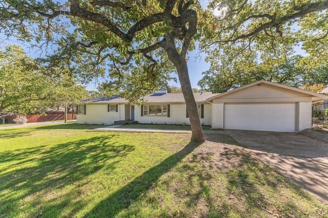 single story home featuring a garage and a front lawn