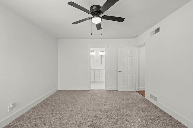 spare room with ceiling fan and carpet