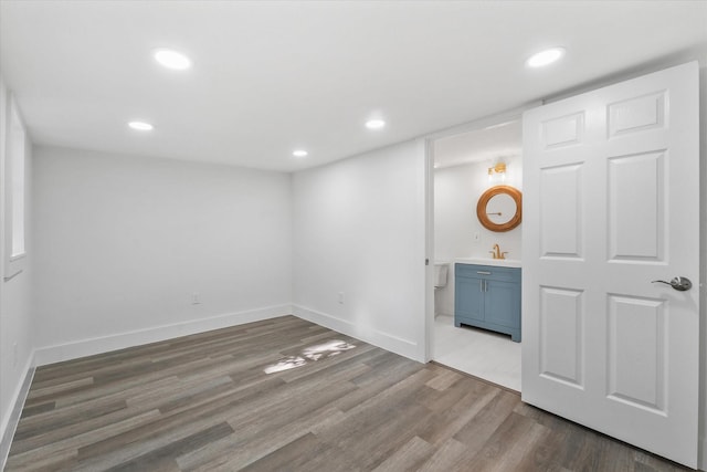 empty room with sink and wood-type flooring