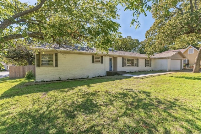 single story home with a garage and a front lawn