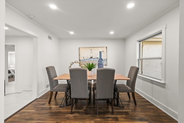 dining space with crown molding and dark hardwood / wood-style flooring