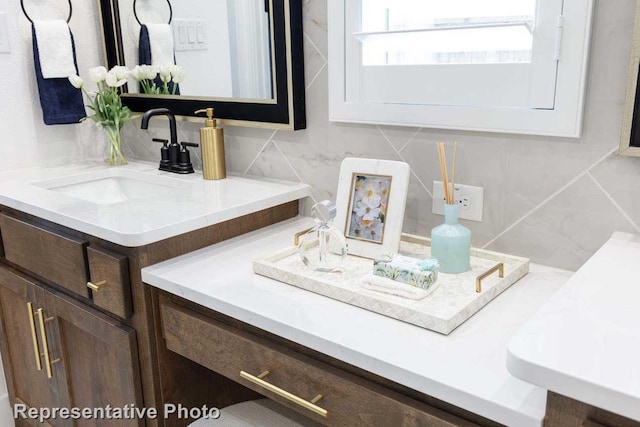 bathroom featuring tasteful backsplash and vanity