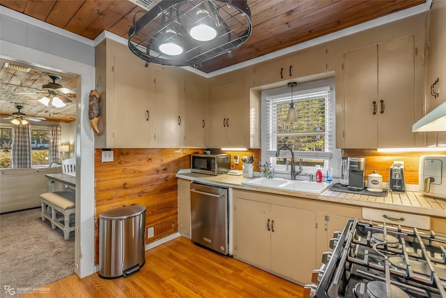 kitchen with sink, light wood-type flooring, appliances with stainless steel finishes, and wooden ceiling