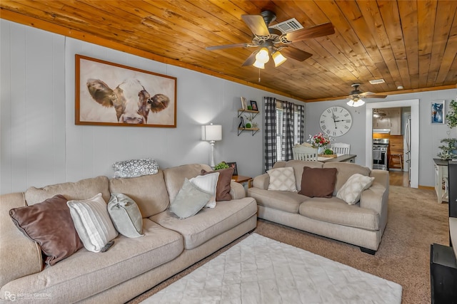 living room with wooden ceiling, carpet floors, ceiling fan, and ornamental molding