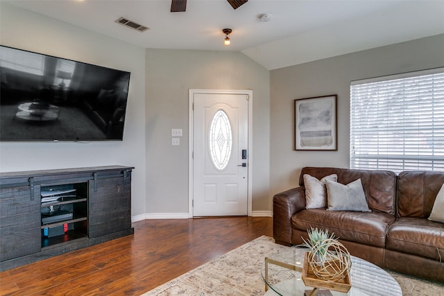 living room with ceiling fan, dark wood-type flooring, and lofted ceiling